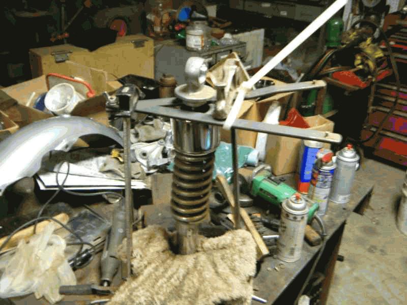 Compressing the rear shock in the vise.